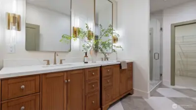 Gorgeous Primary Bathroom with quartz counters, undermount sinks, tile flooring and shower.