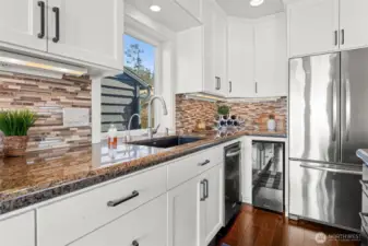 Custom white shaker cabinets, wine fridge& french door style fridge