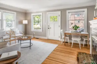 The charming Living Room with refinished oak floors includes a sweet dining area.