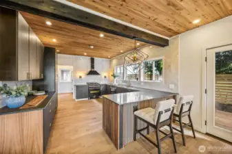 Quartz counter tops, top end appliances and over the top cabinetry and storage pantry await the chef!  There are doors leading to all the decks for easy access to outside.