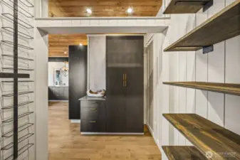 Walk in pantry with wine rack and ample shelving for smaller kitchen appliances.  Food stuffs can be stored in the cabinets!