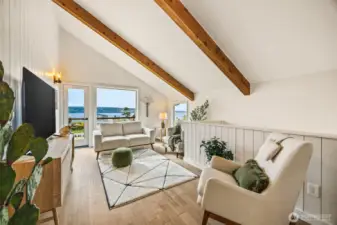 Heading upstairs there is a living area with french door to the upstairs deck and beautiful views!