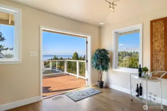 What a space to entertain or take in the views all day. The outswing French doors provide room to enjoy more space inside and lead you right outside to your expensive deck with view od Puget Sound and the Olympic mountains.