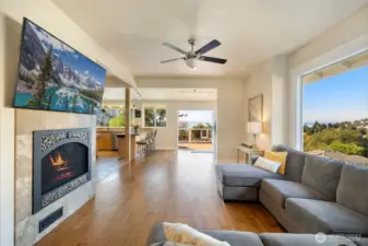 Large living room with open floor plan to kitchen and amazing access to deck. Large picture window with more views. And you can't miss the double-sided fireplace.