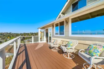 Spacious deck of the back of the home offers plenty of space for the barbecue and patio table