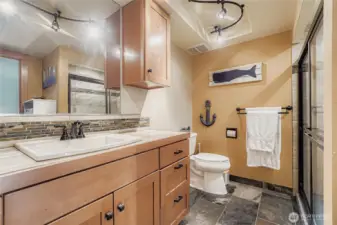 Designer bathroom with slate floor and porcelain tile surround in the shower.