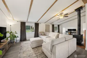 Living/Great room.  New paint, trim, doors, LVP flooring in main areas; carpet in the bedroom.  Functioning wood stove as secondary heat source.