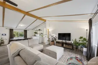 Another view of greatroom/living space from front door entrance.  New paint, trim, doors, flooring, with a vaulted ceiling.