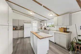 View of kitchen, new flooring, paint, cabinets, trim, great storage.