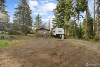 Another view of separate RV living area with nearby covered entertainment and living/storage building.