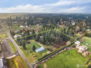 Another aerial view of shy 4 acre property,  Manufactured home in the forefront with peekabo look at second RV living site. Boundary lines are estimated; for informational purposes.  East Olympia Elementary just across 87th from the property.
