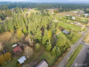 Another aerial of the shy 4 acres boasting private living but close to services and fun, Mature trees, individual well, fully refurbished manufactured home with second RV living space.