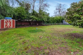 Spacious level yard with shed