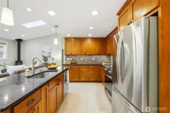 Large island, beautiful cabinetry, granite counters, and tile floors provides a cheery environment for entertaining!