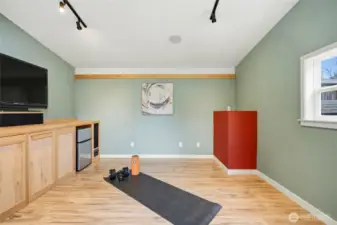Or how about a home gym? With built in speakers, a wall of cabinetry, and a TV and mini fridge that stay, the whole family will want to claim this space!