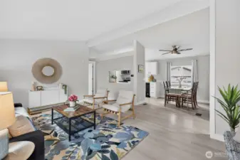 Vaulted ceilings and natural light create a bright, airy feel, while the primary suite just off the living room welcomes the morning sun through its north & south-facing windows.