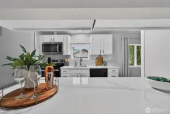 The pass-through window keeps the living area and kitchen seamlessly connected—perfect for easy conversation, shared moments, and effortless entertaining.