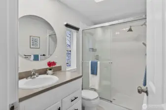 Bright and thoughtfully updated, the ¾ ensuite features a glass-enclosed shower, modern vanity, and clean finishes that create a fresh, spa-like feel.