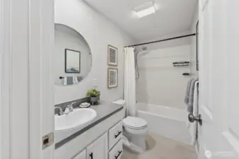 Bright and well-appointed, the full bathroom offers comfort and convenience for the additional bedrooms.