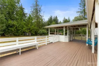 an expansive enclosed back deck on the main home