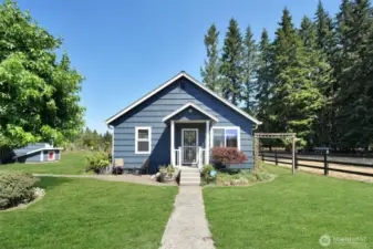 Front of home, 40 year roof installed 2011, fresh paint 2018, garage and wellhouse to the left, grass has been retouched