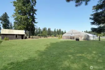 Original homestead on left, possible farm stand, 30 x 96 greenhouse on right with frost free spigots, plumbing and wash basins that drain to septic, grass has been retouched