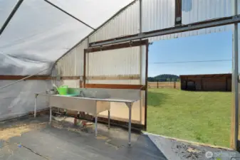 South facing front entrance of greenhouse, wash basin and vegetable prep area, plumbed and drains to septic, grass has been retouched