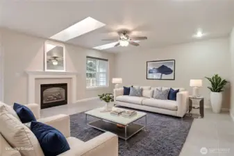 Family room view, love the skylights, beautiful elegant gas fireplace, plenty of space to arrange your furniture any way you desire. ***Virtually Staged***
