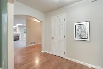 Entry hallway toward family room, powder room is the door to your right.