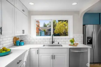 Quartz countertops plus a brand new stainless steel fridge.