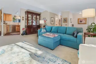 Formal living room with vaulted ceilings, sliding door to front patio and picture window overlooking the community greenbelt and trail