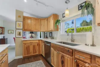 Remodeled kitchen features Hickory cabinets, quartz counters, LVP floors, GE cafe stainless appliances and an eating bar to the dining room.