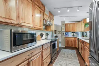 Remodeled kitchen features Hickory cabinets, quartz counters, LVP floors, GE cafe stainless appliances and an eating bar to the dining room.