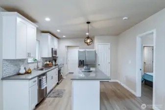 Kitchen with quartz counters, island and all appliances