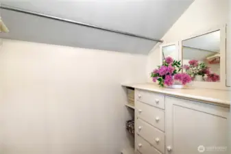 Built-in dresser & mirror in walk-in closet