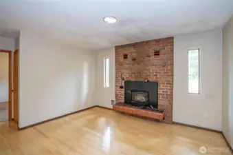 Family room with wood burning fireplace.