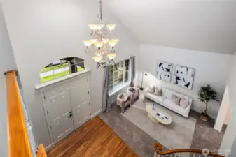 Soaring 22' ceilings create a wow factor entry and formal living space. New carpeting and freshly painted interior walls, trim and doors make this home move in ready.  Plenty of space allows for larger furnishing and art displays.  This room is always drenched in sunshine!