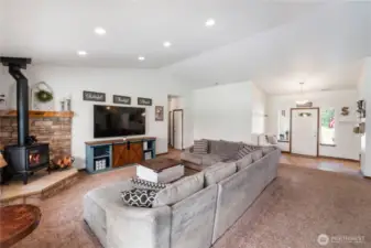 Great room features wood fireplace with sandstone hearth, stone surround and wood mantle for ambiance and those chilly winter nights.