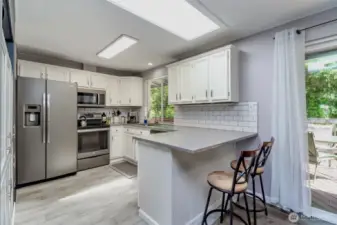 Modern, open-concept kitchen with bar seating, perfect for casual dining