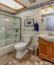 Bright guest bathroom with a skylight, adding natural light