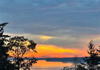Southwest face Puget Sound views from upper level living and view deck. Enjoy sunrises to sunsets across an ever-changing sky.