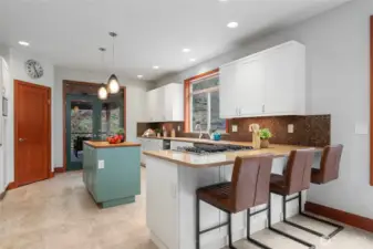 Gorgeous kitchen. Breakfast bar, gas range, tile backsplash and large pantry.