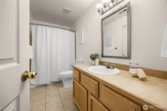 Full bath in the daylight basement with both bedroom and rec/family room access