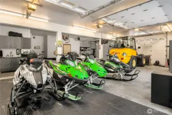 The garage below the 2nd house has built-in shop area, in-floor heating and oversized garage doors to park all of your favorite toys. Two additional garage spaces in the main house.