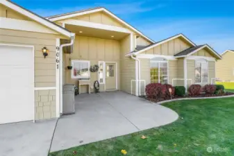 The covered front patio is tall and wide.