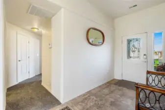 The front entryway leads you down the hall to the coat closet and first two bedrooms