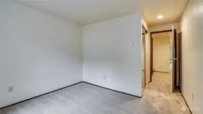 Another angle of the guest bedroom; more of the natural light along with mirrored closet doors maximize the space.