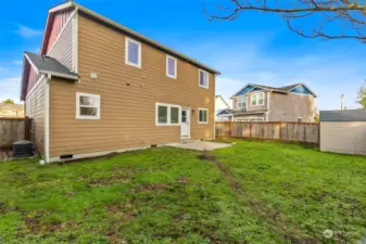 The A/C unit is in this photo on the left side of the home. You can also see the shed over on the right side.