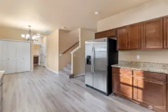 The pantry is inside those white doors. Down that hall way is a half-bath to the left, the large laundry straight ahead, and the door to the garage.