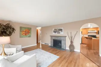 Living Room w/ Fireplace and Hardwood Flooring.